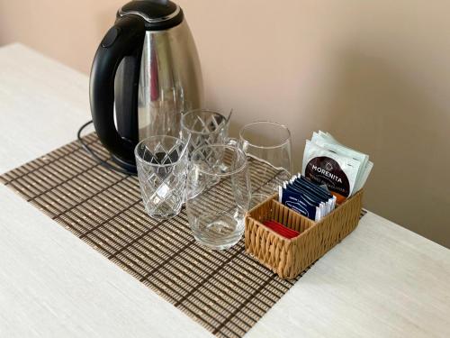a table with glasses and a tea pot and a tray with a tea kettle at Hotel SMA in Puerto Iguazú