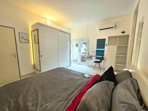 a living room with a couch and a room with a desk at Cozy apartment with private patio in Lomé