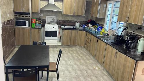 a kitchen with wooden cabinets and a black counter top at Kourosh in Muscat