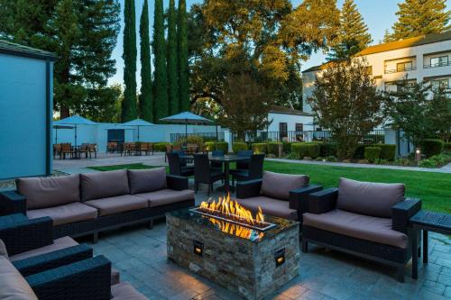 a patio with couches and a fire pit at Courtyard Sacramento Airport Natomas in Sacramento