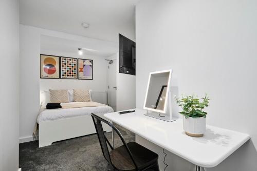 a white room with a desk and a bed at Luxury Lower-Level Two Bed Apt in Headingley