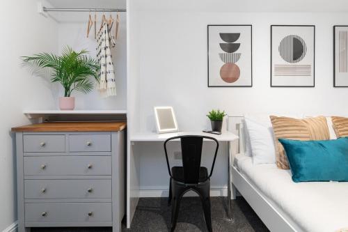 a bedroom with a bed and a desk with a laptop at Back Brudenell Mount in Headingley