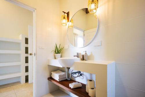 a bathroom with a sink and a mirror at Serene Jungle Escape with Private Pool by Sea N' Rent in Haad Chao Phao