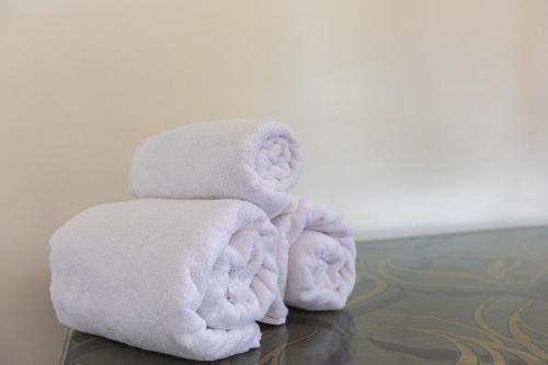 a stack of towels sitting on a table at Villa Vedic Oasis by JadeCapsPool4 BHKAC in Sikarpur