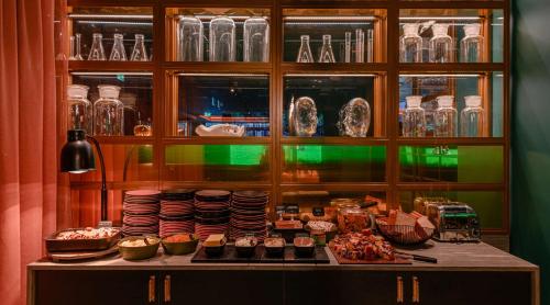 a display case with a bunch of food on a table at Marski by Scandic in Helsinki