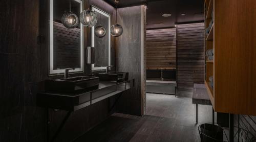 a bathroom with two sinks and a large mirror at Marski by Scandic in Helsinki