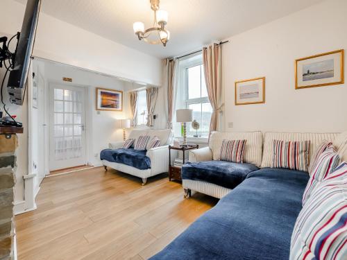 a living room with a couch and a table at Toll Bar Cottage in Whitby