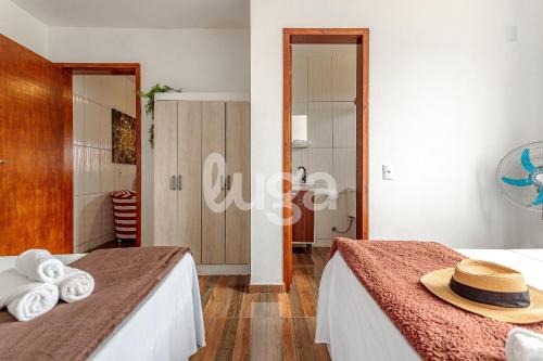 a bedroom with two beds with towels on them at LUGA: Peaceful Retreat | Lagoon & Imbituba in Imbituba