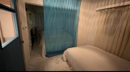 a small bedroom with a bed and a window at 経堂の小さな一棟貸wakusei in Tokyo