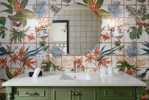a bathroom with a sink and a mirror at Solar do Sabão - Your Gathering Place in Relva