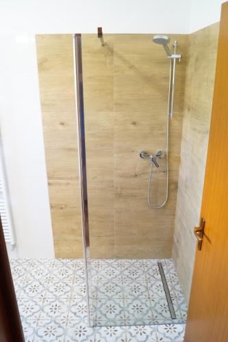 a shower with a glass door in a bathroom at Casa Florian in Vito dʼAsio