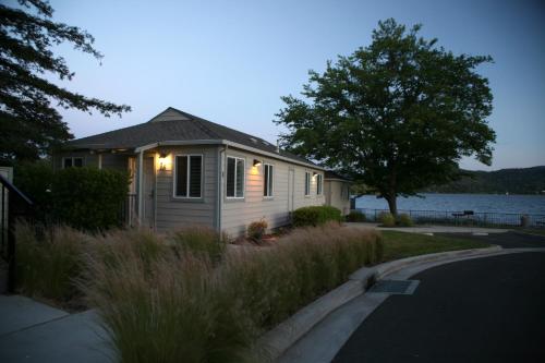 a small house with lights on it next to a lake at Clear Lake Cottages & Marina in Clearlake