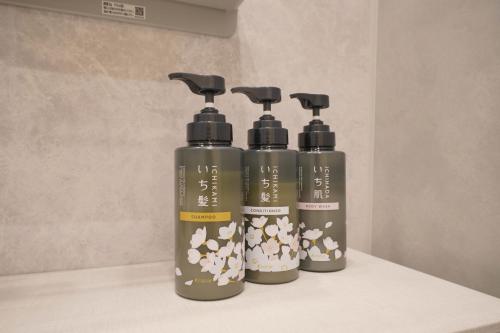 a group of three shampoo bottles sitting on a counter at LinksHotel上野 in Tokyo
