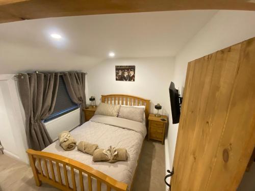 une chambre avec un lit avec deux ours en peluche dessus dans l'établissement Seatons Hidden Gem Charming Holiday Cottage with Garden, à Sigglesthorne