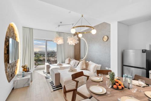 a living room with a white couch and a table at Luxury Waters Edge Residence in Abu Dhabi