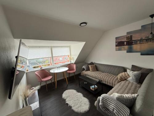 a living room with a couch and a table at Cozy Vintage Home in Sønderborg