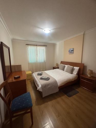 a hotel room with a bed and a chair at Ajuda Mar Holidays in Funchal