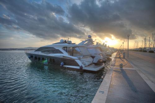 a boat is docked in the water with the sunset at Boutique Apartments Ad Astra in Bibinje