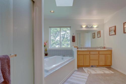 a bathroom with a tub and a sink and a mirror at Amber Sunset in Mosier