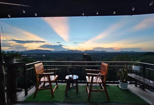 two chairs and a table on a balcony with a view at BaanPhutawanLanta in Ban Mo Nae