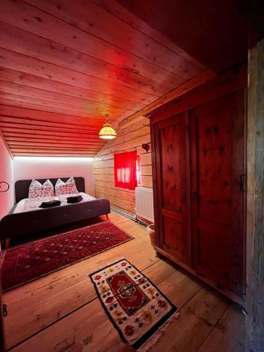 a bedroom with a bed in a wooden room at Trail & Tiefschnee Lodge in Reith im Alpbachtal