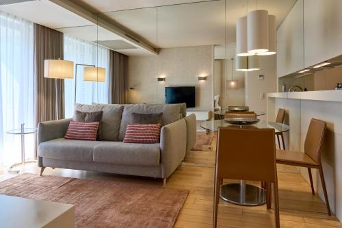 a living room with a couch and a table at Serviced Apartments Boavista Palace in Porto