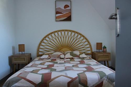 a bedroom with a large bed and two night stands at Apartee - Charmant T2 en centre ville de Laval in Laval