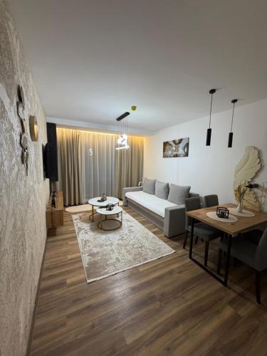 a living room with a couch and a table at Gold Elegant & Spa Kop in Kopaonik