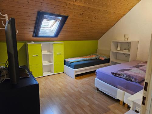 a bedroom with a bed and a tv in a room at Apartment Dorfstrasse 16 in Leuzigen