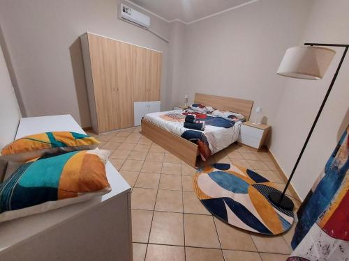 a bedroom with two beds and a lamp in it at Al vicolo dei Mori in Trecastagni