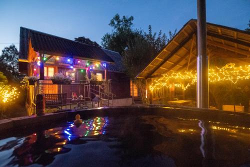 a house with a swimming pool with christmas lights at Pipi Vityilló in Füzérradvány