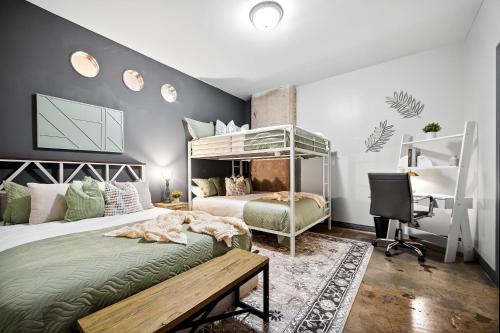 a bedroom with a bed and a desk and a computer at The Magnolia - Farmhouse Loft - Sleeps 10 - Valet in Dallas