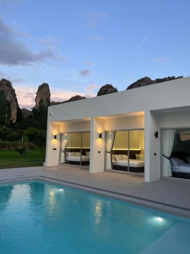 a house with a swimming pool in front of it at วันทน่า พูลวิลล่า เนินมะปราง in Ban Mung