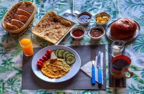 a table with a plate of breakfast food and juice at Ocean Hideaway - Sea View in Essaouira