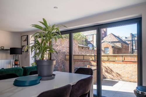 a plant sitting on a table in a living room at Luxury 4BDR House By Torr Property Group Contractors Accommodation With Free Gated Secure Parking & Private Patio Garden Liverpool in Liverpool
