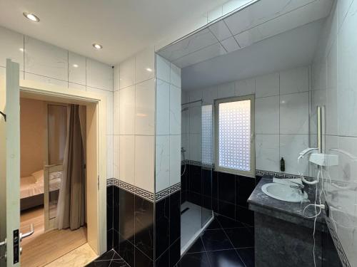 a bathroom with a sink and a mirror at AMH Hotel Durres in Durrës