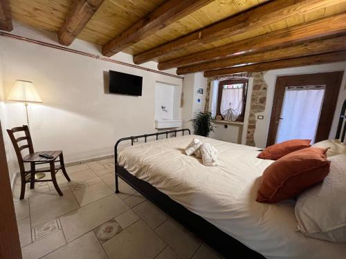 a bedroom with a bed and a table and a chair at Belvedere Apartments Valdilana in Trivero