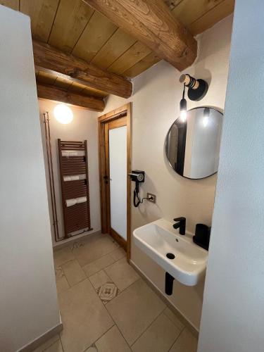 a bathroom with a sink and a mirror at Belvedere Apartments Valdilana in Trivero