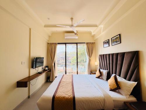 罗纳瓦拉The Vantage Point Resort & Spa的一间带床的卧室，配有大窗户