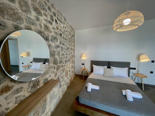 a bedroom with a large mirror and a bed at Ocean Bliss Villa, By Hellocrete in Kerames