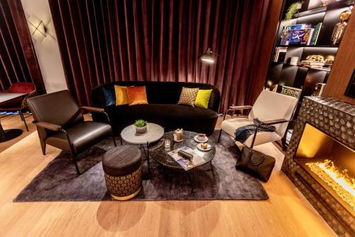a living room with a couch and a fireplace at Best Western Plus Crystal, Hotel,Bar & Spa in Nancy