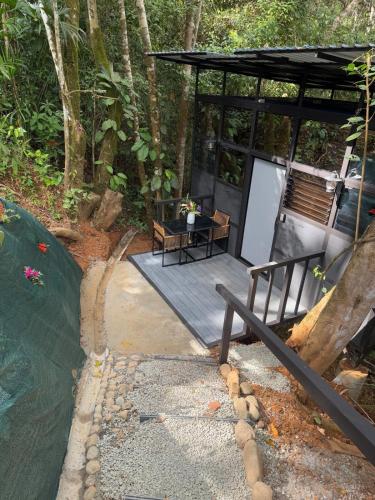 a wooden deck with a table and a bench at Jungle Loft in Platanillo