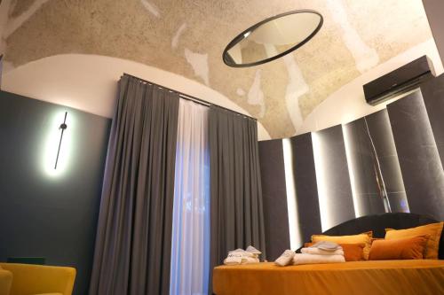 a bedroom with two beds and a mirror and a window at Nenna's Suite Room in Scafati