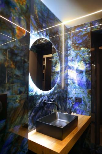 a bathroom with a sink and a mirror at Nenna's Suite Room in Scafati