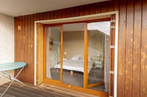 a room with a glass door leading to a bedroom at L'appartement du Berger in La Correrie