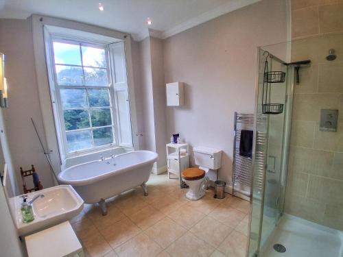 a bathroom with a tub and a sink and a shower at Hillside House in Saline