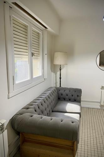 a couch in a living room with a window at Dpto SAN MARTIN in Azul