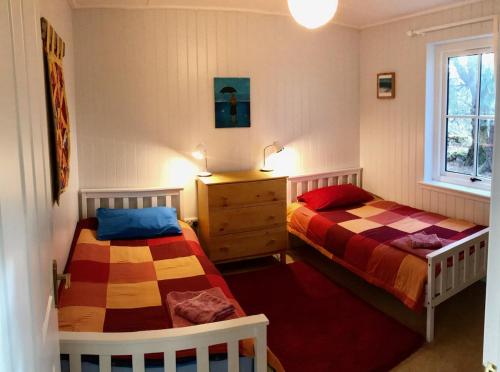 a bedroom with two beds and a window at Ardshiel in Foyers