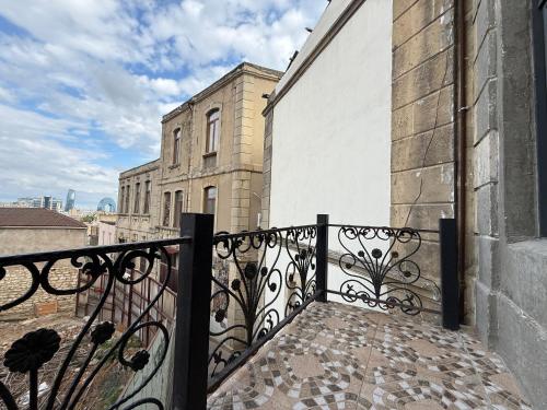 a balcony with a wrought iron railing on a building at Briiz Hotel Baku in Baku