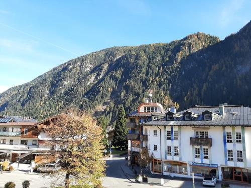 a view of a town with a mountain in the background at Boardwalk center in Mayrhofen